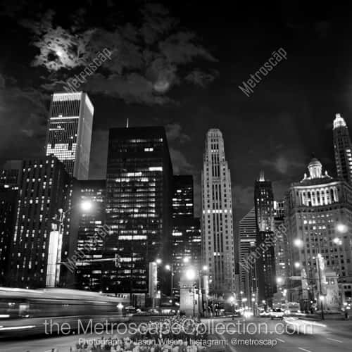 A Full Moon Rises Behind the Clouds over the Magnificent Mile