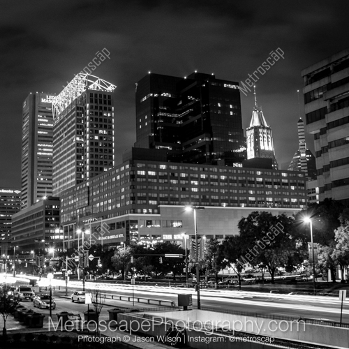 Traffic in the Foreground of the Baltimore Skyline Along Pratt Street