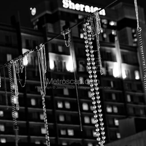 Matte Black MDF Framed Black and White New Orleans Photograph: Beads Hang above Bourbon Street in the French Quarter in a Square Matte Black MDF Frame